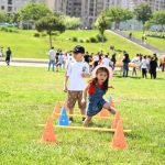 Kids playing in front of the Heydar Aliyev Center, one of the best family-friendly places for tourists to visit in Baku