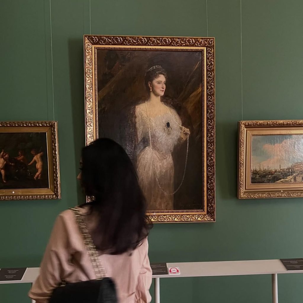 A woman in front of a portrait in Azerbaijan National Museum of Art