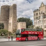 Baku hop-on hop-off city tour bus in front of Maiden Tower