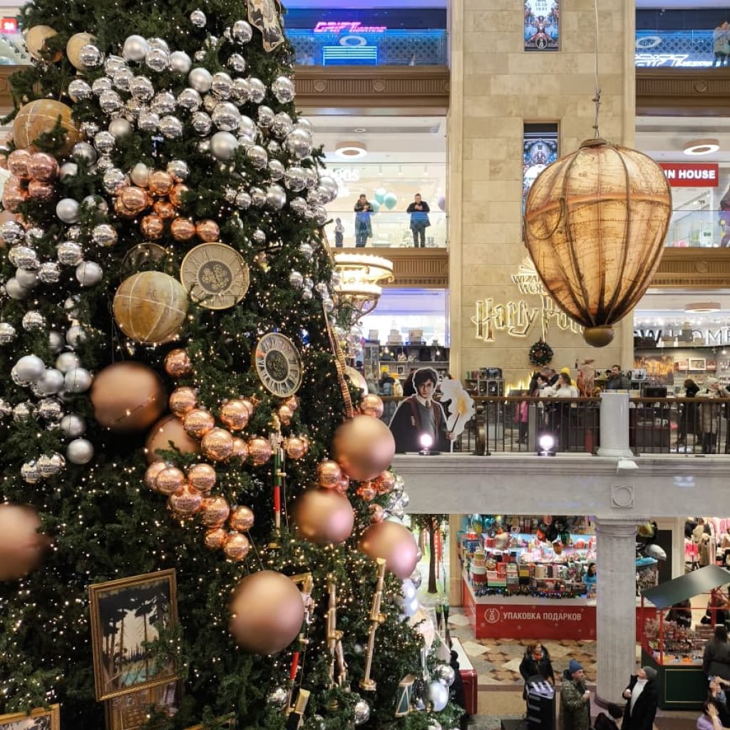 Interior of Central Children’s Store, Moscow, with shops and a tall New Year tree