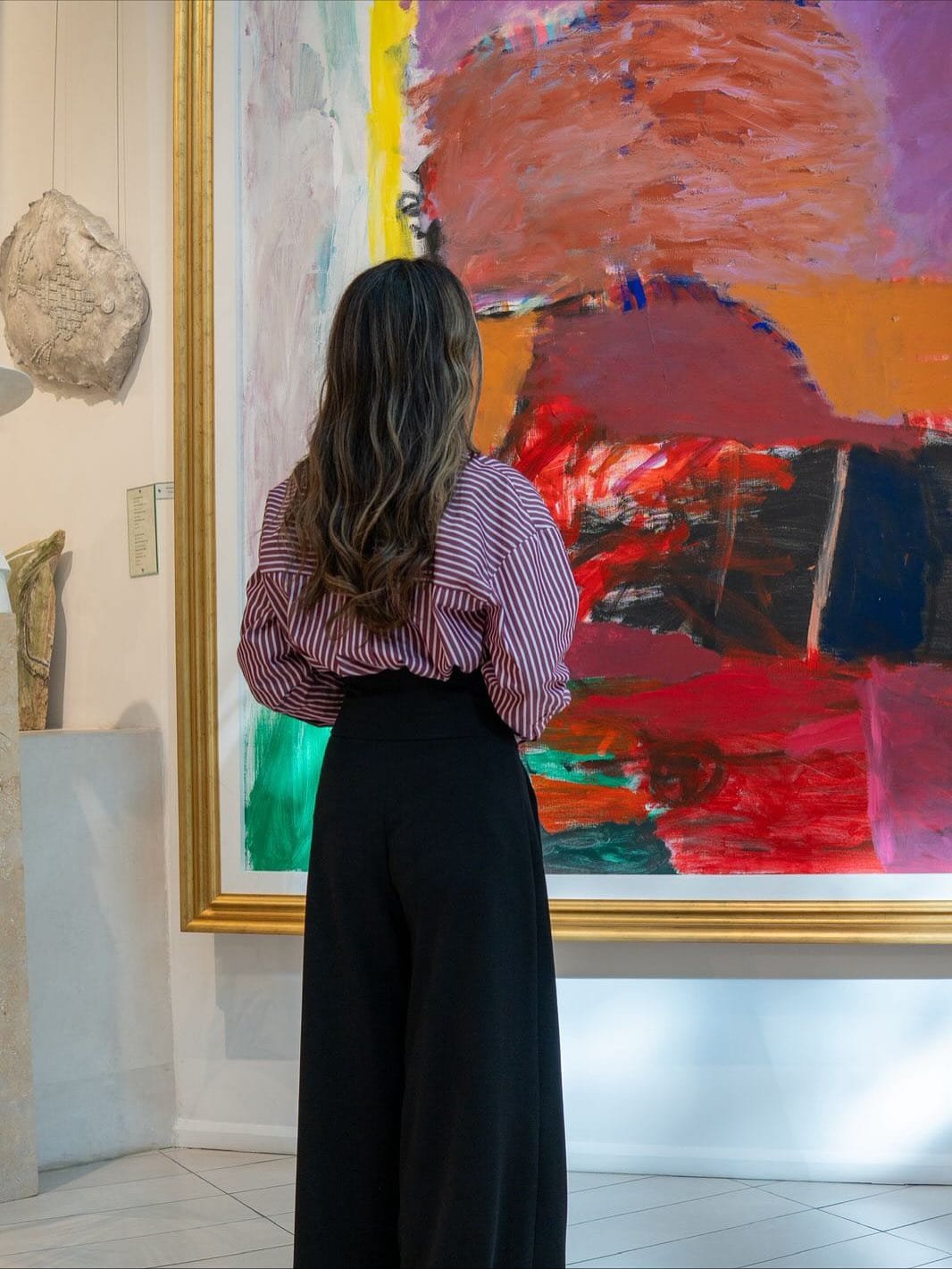 A girl viewing a portrait in The Museum of Modern Art in Baku